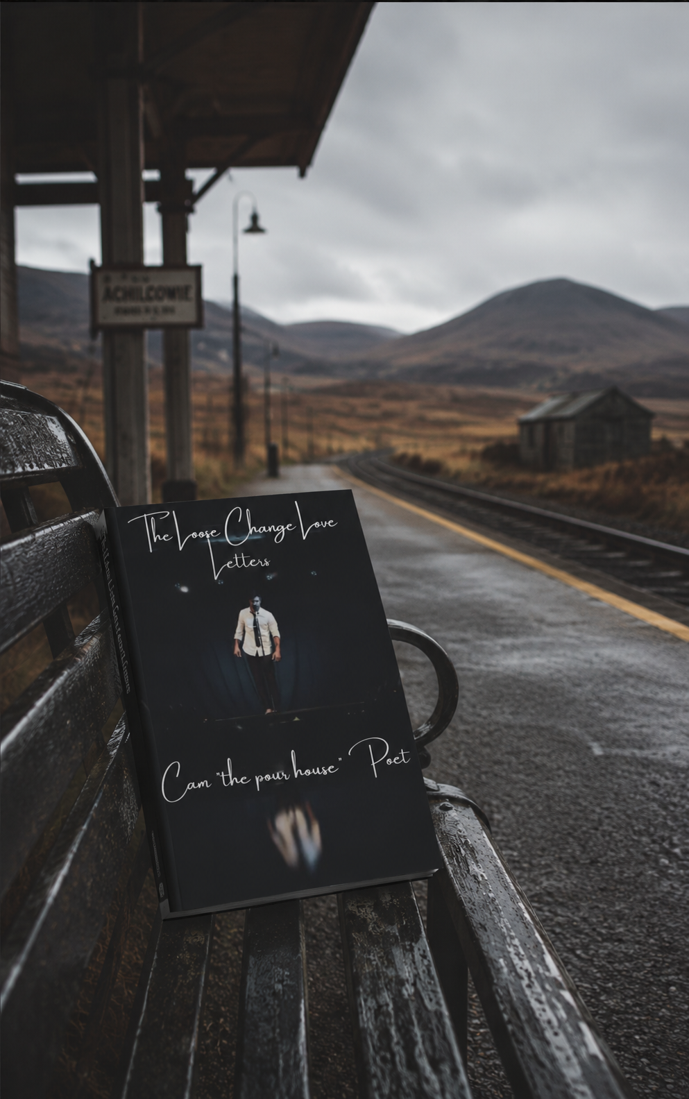 The Loose Change Love Letters resting on a rainy train station bench in the Highlands